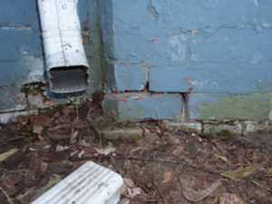 cracked painted blue brick foundation