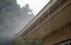 rain pouring down from roof of house