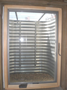 view through the inside of a basement egress window showing a steel well
