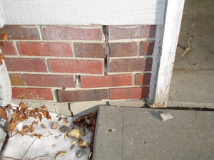 Cracked brick foundation due to street creep