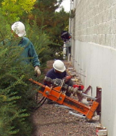 Crew Installing Wall Anchors Onto Exterior Wall